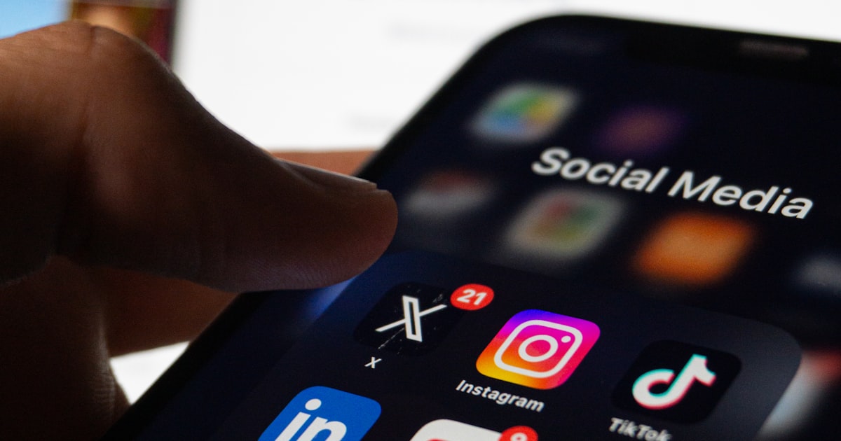 Smartphone screen showing social media apps in dark setting