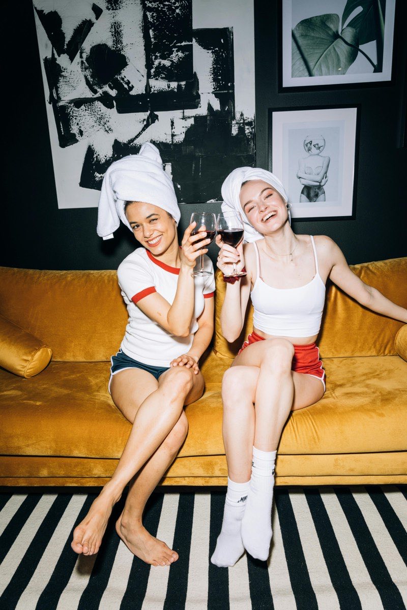 Two women having a genuine conversation on a cozy couch