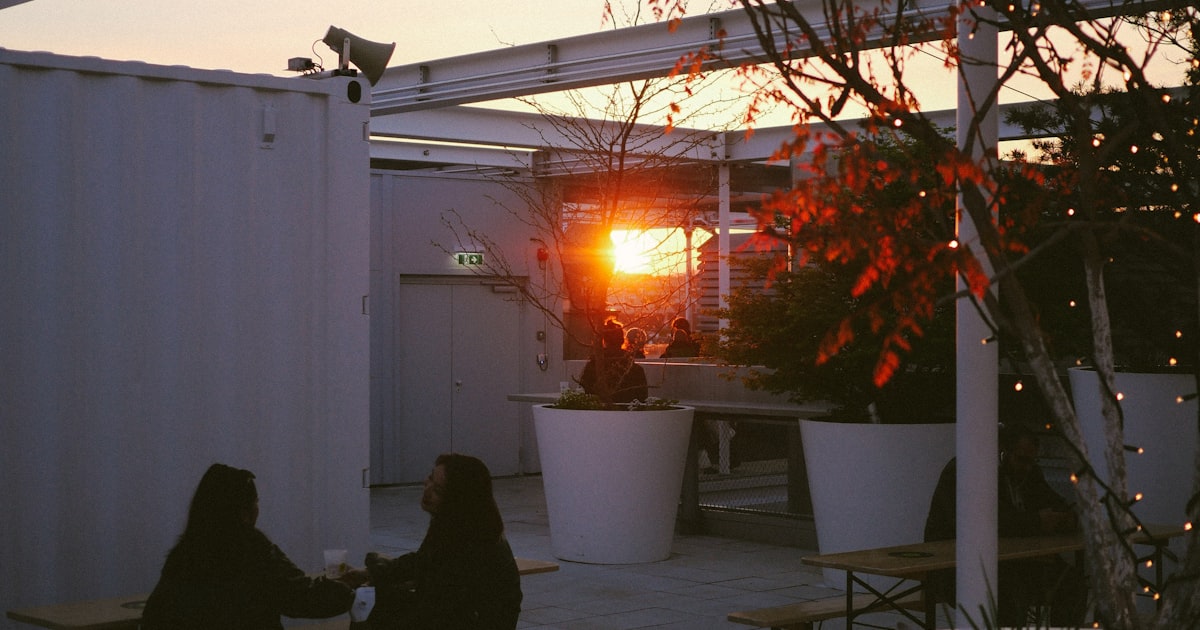 Two people sharing a warm conversation at sunset