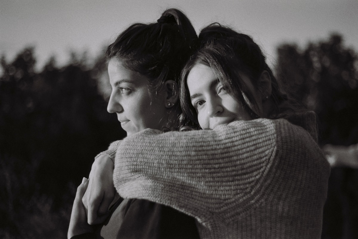 Two women hugging warmly, a close and trusting friendship