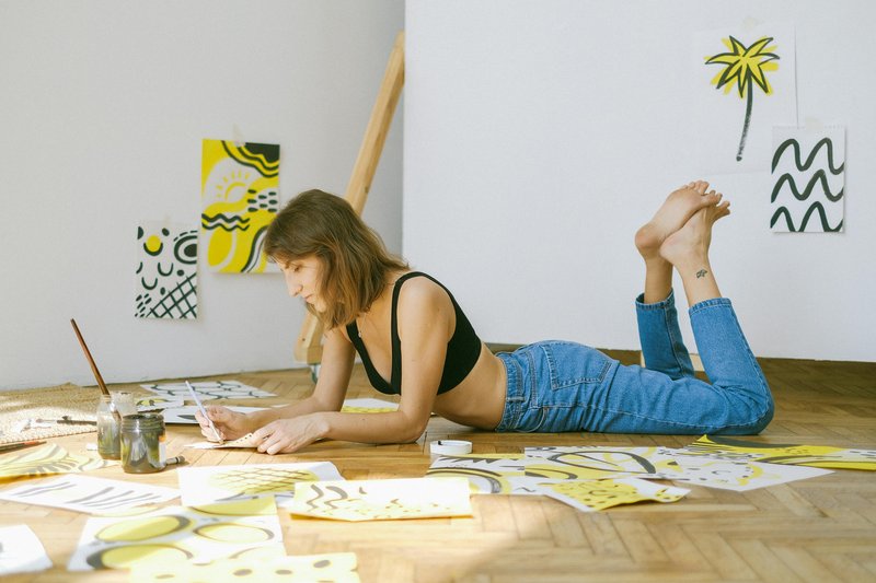 Person sitting alone by a window, reading and content